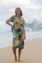 Load image into Gallery viewer, Animal Print pattern with yellow, blue, white and black spots - one size only. Dress for women or girls with transpassed, envelope style. Dress with short sleeves. You can wear as a beach cover up or to go out. Dress material: Viscolin. Made in Brazil.
